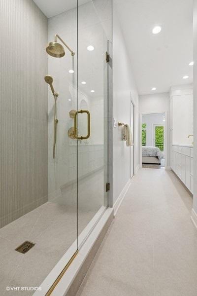 ensuite bathroom with a stall shower and recessed lighting