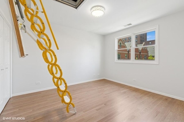 empty room featuring wood finished floors and baseboards
