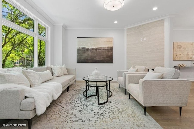 living area featuring ornamental molding, wood finished floors, recessed lighting, and baseboards