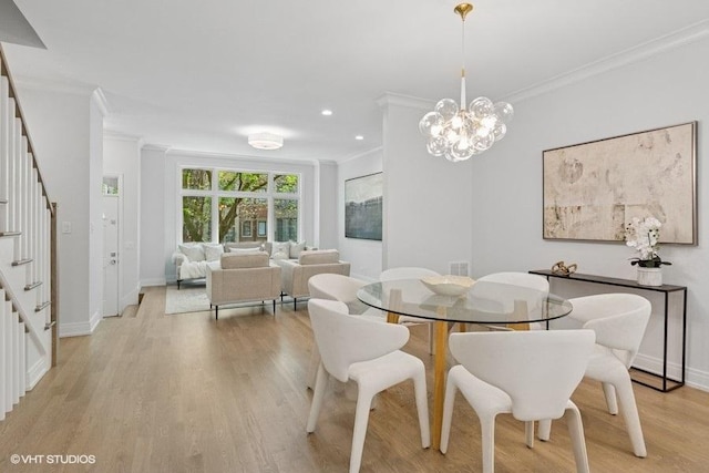 dining room featuring stairs, crown molding, light wood-style floors, a chandelier, and baseboards