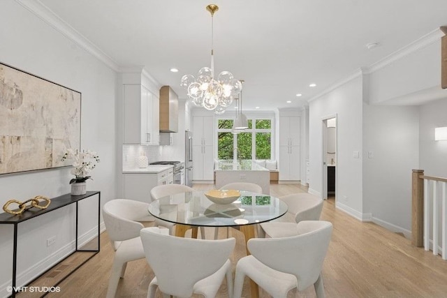 dining room with crown molding, light wood finished floors, recessed lighting, baseboards, and a chandelier