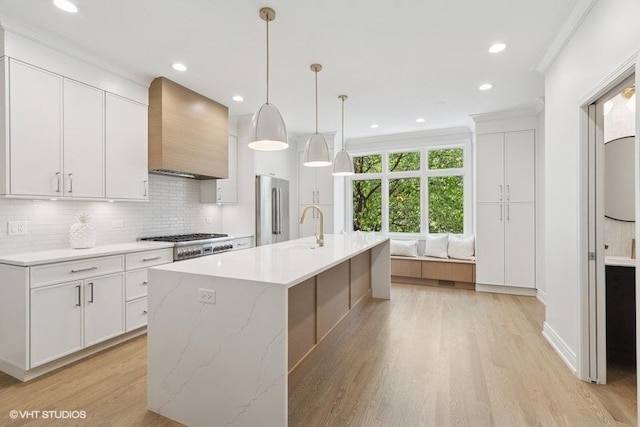 kitchen with custom exhaust hood, stainless steel appliances, light wood-type flooring, tasteful backsplash, and recessed lighting