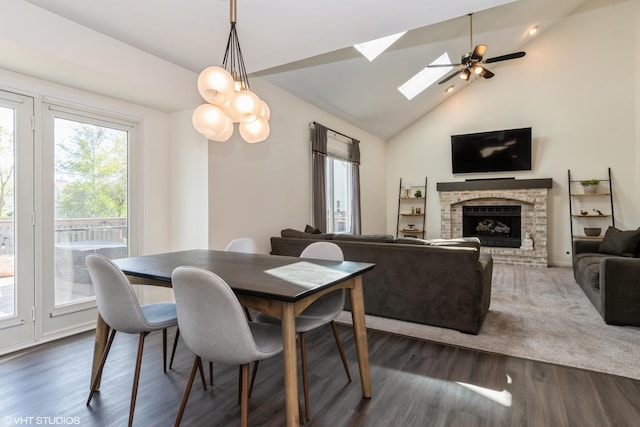 1449 Mesa Dr, Bolingbrook, IL 60490 - dining area featuring a skylight, a brick fireplace, wood finished floors, high vaulted ceiling, and a ceiling fan