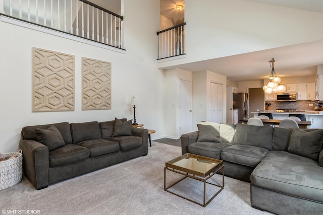 1449 Mesa Dr, Bolingbrook, IL 60490 - living area with a high ceiling, carpet flooring, and a chandelier