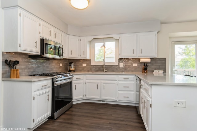 1449 Mesa Dr, Bolingbrook, IL 60490 - kitchen with stainless steel appliances, a sink, a peninsula, white cabinetry, and healthy amount of natural light