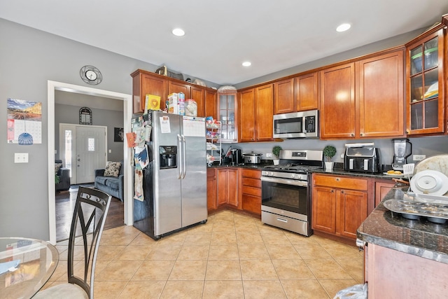 260-262 Chaparral Cir, Elgin, IL 60120 - kitchen featuring stainless steel appliances, brown cabinetry, glass insert cabinets, light tile patterned floors, and recessed lighting
