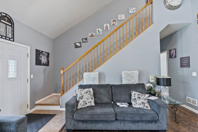 260-262 Chaparral Cir, Elgin, IL 60120 - tiled living room featuring stairs and high vaulted ceiling