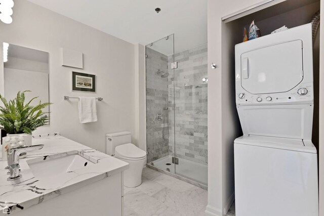 6040 Arbor Ln Unit 102, Northfield, IL 60093 - full bath featuring stacked washer and clothes dryer, marble finish floors, toilet, a shower stall, and vanity