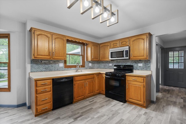 1545 London Ct, Naperville, IL 60563 - kitchen with black appliances, a sink, light countertops, and light wood finished floors