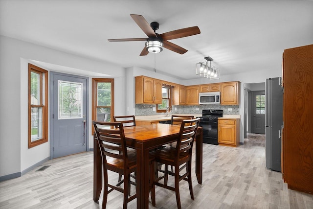 1545 London Ct, Naperville, IL 60563 - dining room with light wood-style floors, ceiling fan, and baseboards
