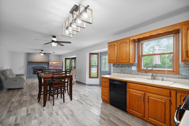 1545 London Ct, Naperville, IL 60563 - kitchen with dishwasher, a sink, tasteful backsplash, light countertops, and light wood finished floors