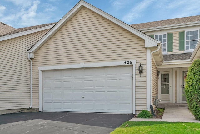 garage with asphalt driveway