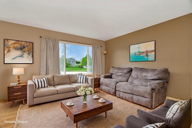 living room with light wood-style flooring and baseboards