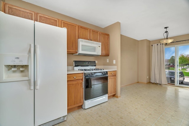 kitchen with white appliances, light countertops, light floors, baseboards, and hanging light fixtures
