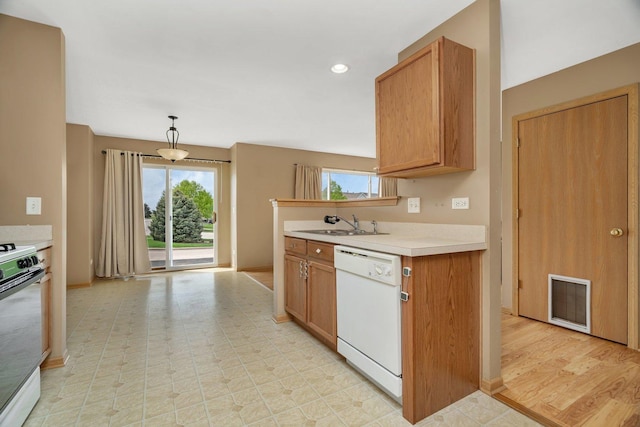 kitchen with white dishwasher, stainless steel range with electric stovetop, healthy amount of natural light, and light countertops