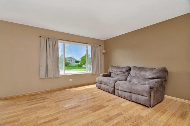 living area featuring wood finished floors and baseboards