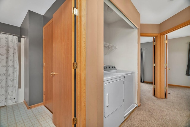 laundry area featuring independent washer and dryer and baseboards