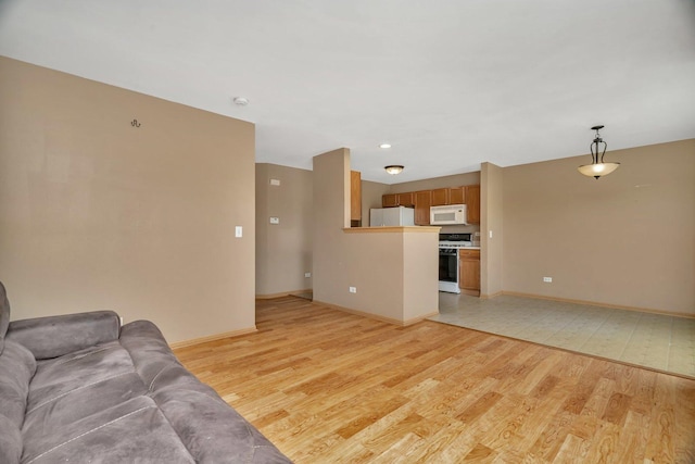 living room with light wood-type flooring and baseboards