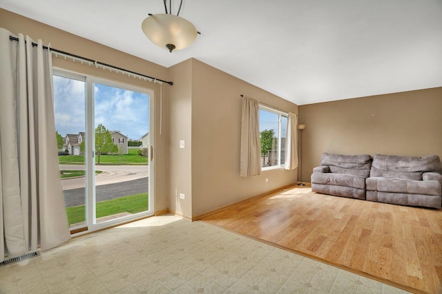 unfurnished living room with baseboards