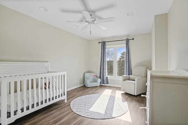 1500 Sandstone Dr Unit 314, Wheeling, IL 60090 - bedroom featuring baseboards, wood finished floors, a crib, and ceiling fan