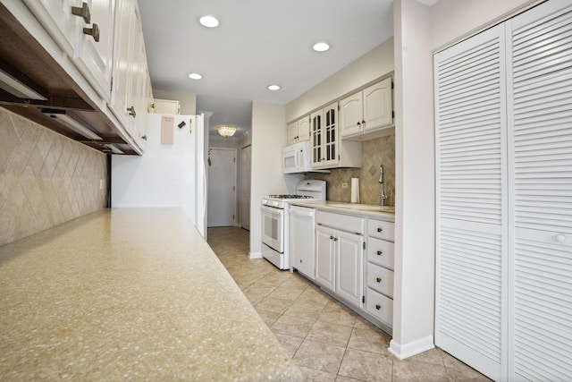 1500 Sandstone Dr Unit 314, Wheeling, IL 60090 - kitchen with white appliances, light countertops, decorative backsplash, recessed lighting, and glass insert cabinets
