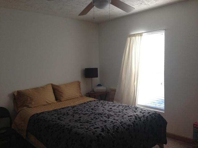 2210 E Michigan Ave, Urbana, IL 61802 - bedroom featuring a textured ceiling, ceiling fan, and carpet