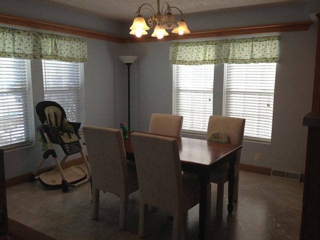 2210 E Michigan Ave, Urbana, IL 61802 - dining area featuring a chandelier and baseboards