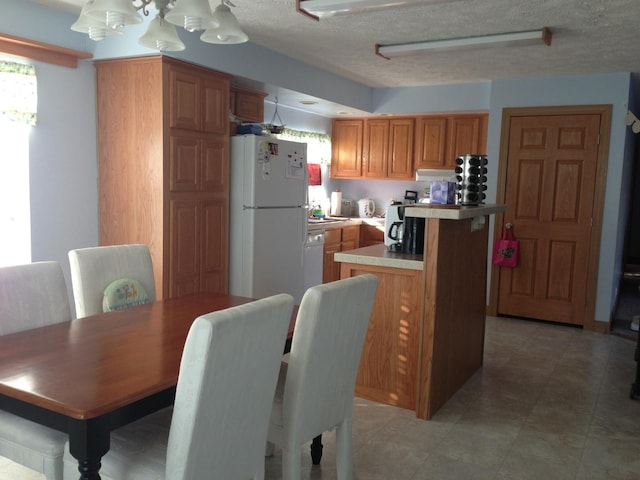 2210 E Michigan Ave, Urbana, IL 61802 - dining area with a textured ceiling and a chandelier