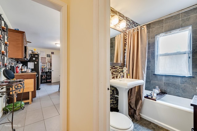 8724 S Jeffery Blvd, Chicago, IL 60617 - bathroom with tile patterned flooring, toilet, and a garden tub