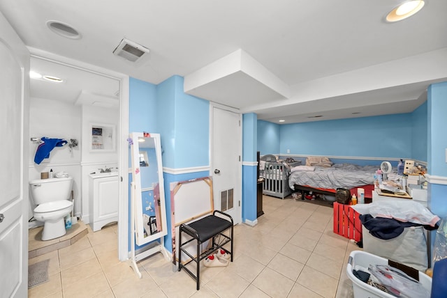 bedroom featuring light tile patterned flooring and a sink