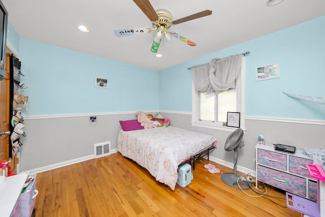 bedroom featuring wood finished floors, baseboards, recessed lighting, and ceiling fan