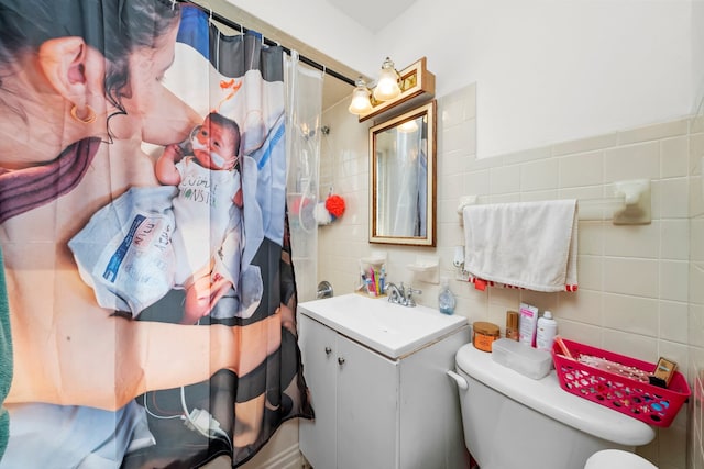 full bath featuring tile walls, toilet, vanity, and curtained shower