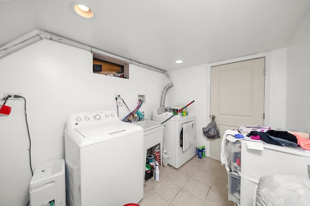 laundry room featuring independent washer and dryer, light tile patterned flooring, and recessed lighting