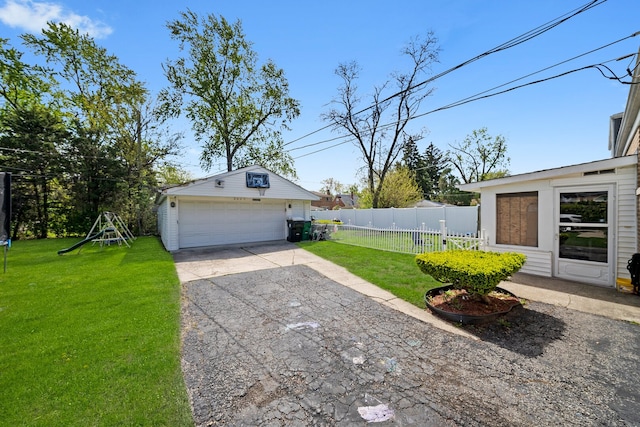 view of yard featuring a detached garage and an outdoor structure