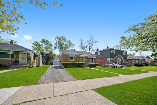 view of front facade featuring a front lawn, brick siding, a residential view, and a detached garage