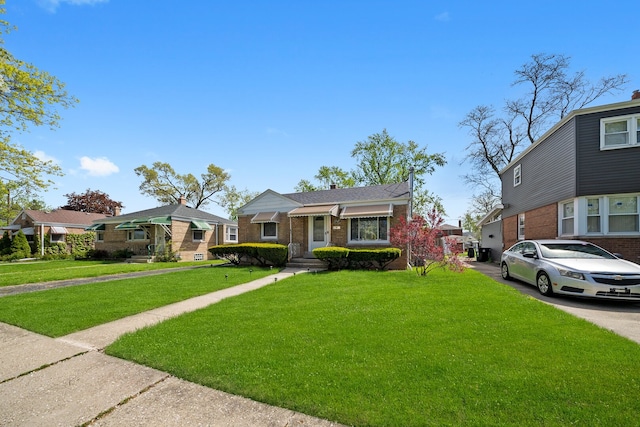 view of front of house featuring a front yard and brick siding