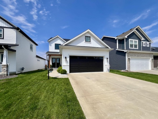 3133 Palmer Dr, Champaign, IL 61822 - view of front of property with board and batten siding, concrete driveway, a front lawn, and a garage