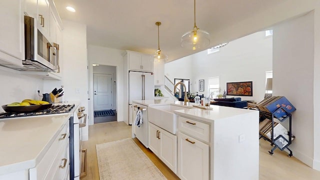 3133 Palmer Dr, Champaign, IL 61822 - kitchen featuring white appliances, a sink, light wood-style floors, and light countertops