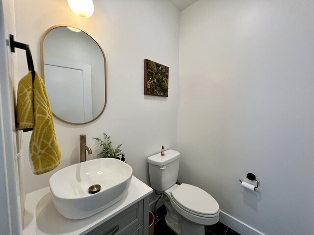 3133 Palmer Dr, Champaign, IL 61822 - half bathroom featuring toilet, vanity, and tile patterned flooring