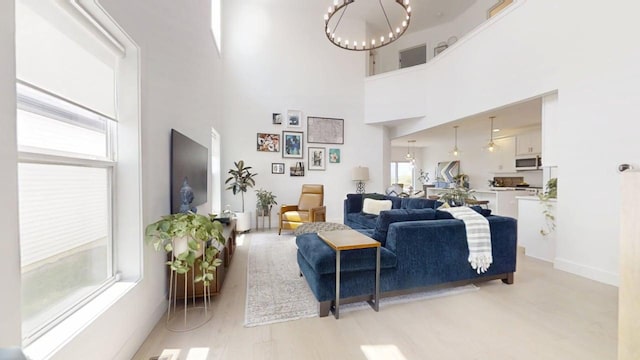 3133 Palmer Dr, Champaign, IL 61822 - living area featuring a chandelier, a high ceiling, and light wood-style flooring