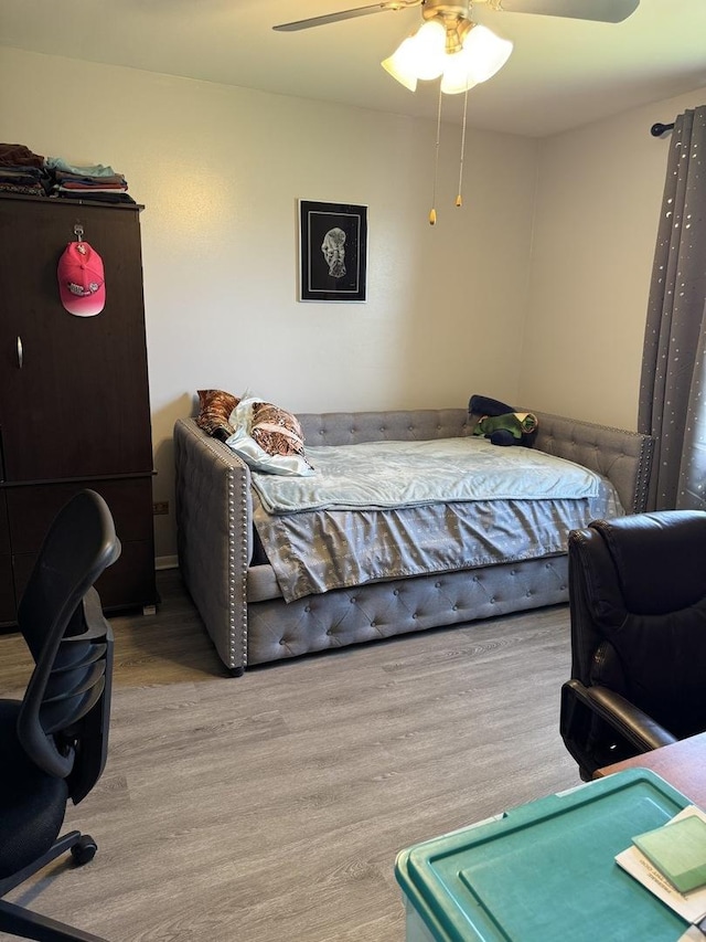 bedroom featuring wood finished floors and ceiling fan