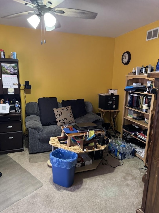carpeted living area featuring ceiling fan