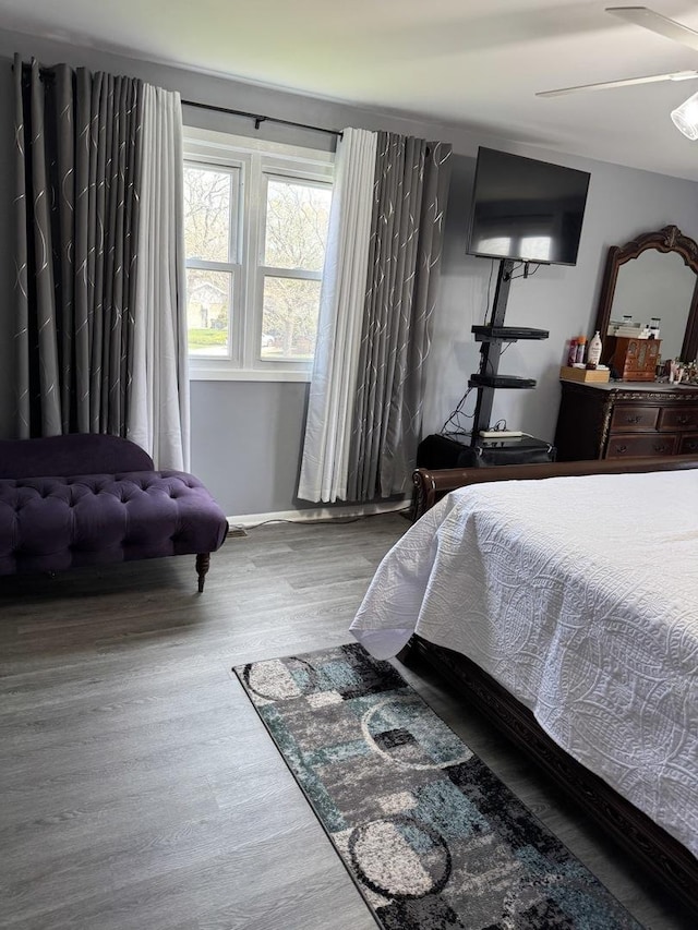 bedroom featuring wood finished floors, ceiling fan, and baseboards