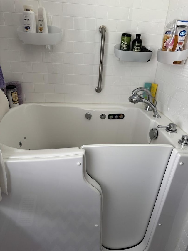 full bath featuring a tub to relax in