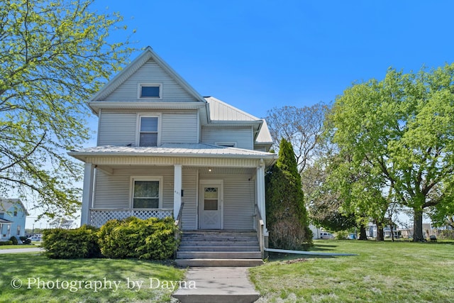 491 S Dearborn Ave, Kankakee, IL 60901 - view of front facade featuring a front yard, covered porch, and metal roof