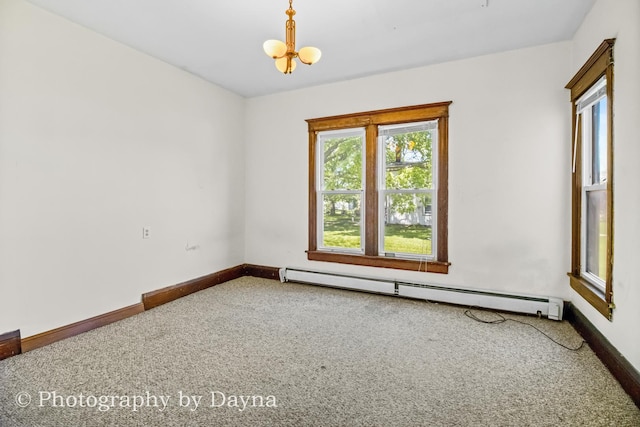 491 S Dearborn Ave, Kankakee, IL 60901 - carpeted spare room featuring a baseboard heating unit, a chandelier, and baseboards