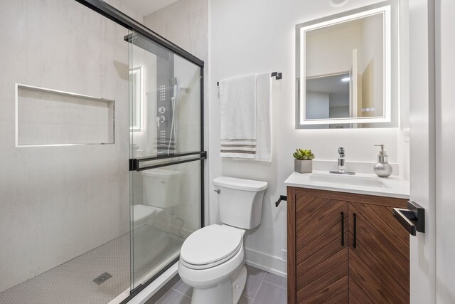 8115 E Prairie Rd, Skokie, IL 60076 - full bathroom with toilet, a stall shower, baseboards, vanity, and tile patterned floors