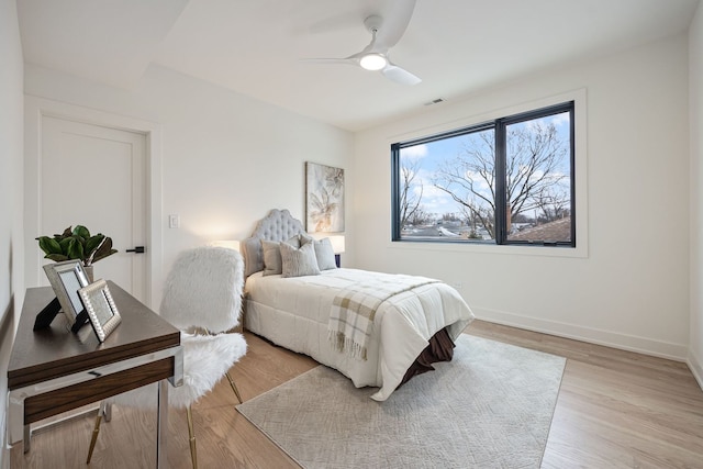 8115 E Prairie Rd, Skokie, IL 60076 - bedroom with light wood-style floors, baseboards, and ceiling fan