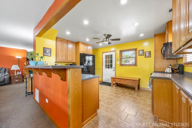 1045 S Grace St, Lombard, IL 60148 - kitchen featuring black fridge, a kitchen breakfast bar, ceiling fan, recessed lighting, and a peninsula