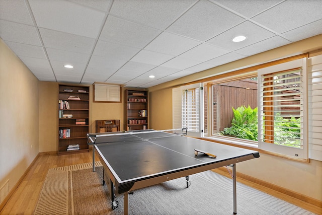 660 Plum Tree Dr, Barrington Hills, IL 60010 - rec room with wood finished floors, baseboards, a paneled ceiling, and built in shelves